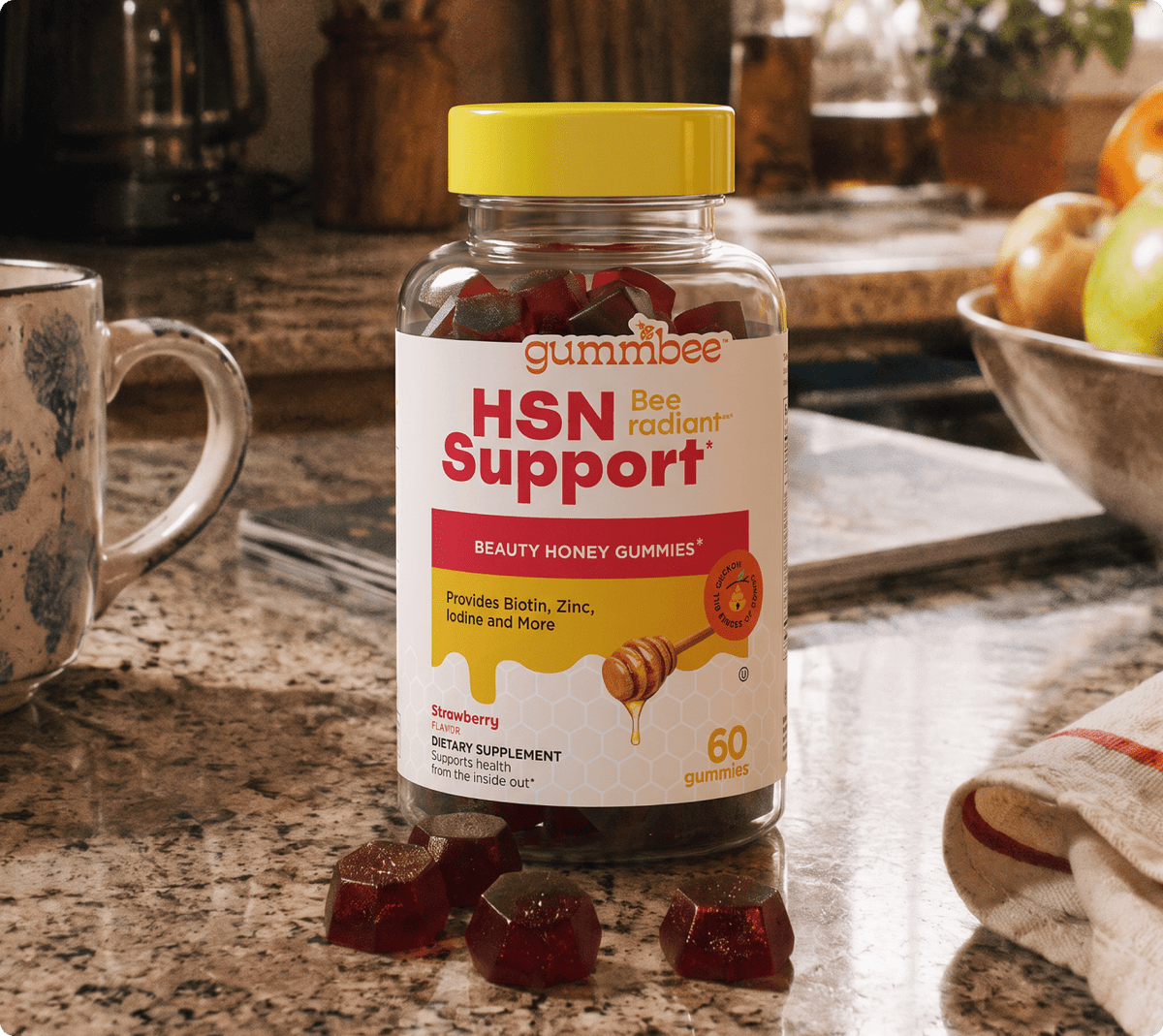 Bee Radiant hair, skin and nails honey gummies bottle on a kitchen counter